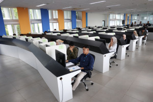 Computer-based UTBK exam room with rows of computers at UGM