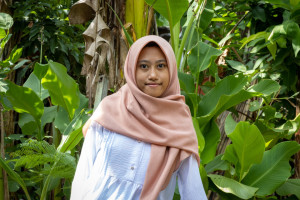Ririn Dwi Nurtyani poses at her home after being accepted to UGM with a full scholarship.