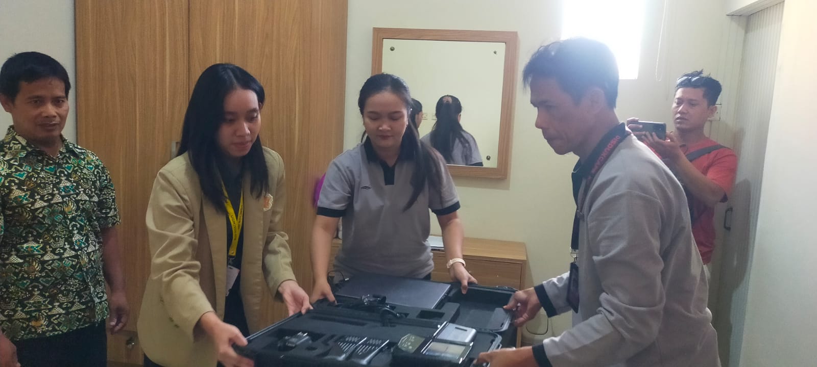 UGM KKN students assist Dukcapil officers during home-based electronic ID card registration for a resident with a disability in Kulon Progo.